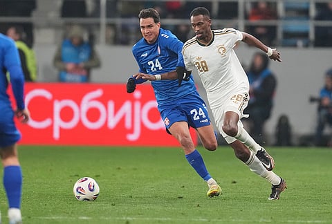 Serbia's Petar Stanic, centre, and Saudi Arabia's Mohamed Kanno challenge for the ball during the international friendly soccer match between Serbia and Saudi Arabia in Backa Topola, Serbia.