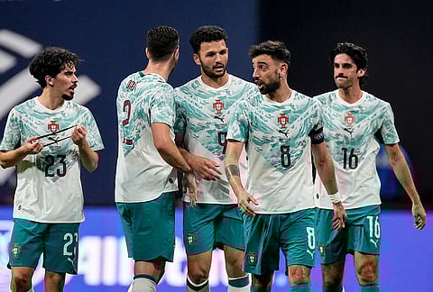 Portugal teammates celebrate a goal against the USA during the first half of an international friendly soccer match, in Atlanta.
