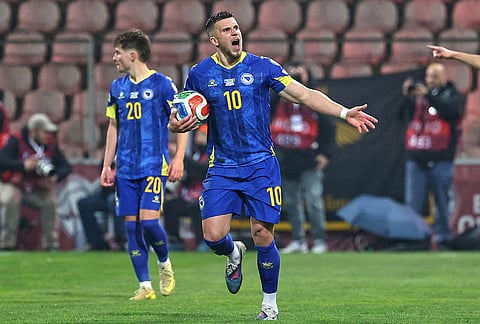 Bosnia's Ermedin Demirovic celebrates after Bosnia's Haris Tabakovic scored his side's first goal during the World Cup qualifying playoff final soccer match between Bosnia and Italy in Zenica, Bosnia.