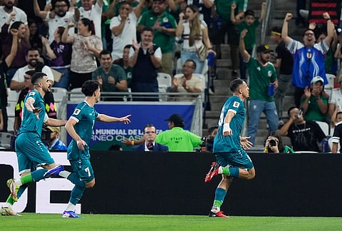 Iraq's Ali Al-Hamadi, right, celebrates scoring his side's opening goal during the World Cup playoff final soccer match between Iraq and Bolivia in Monterrey, Mexico.
