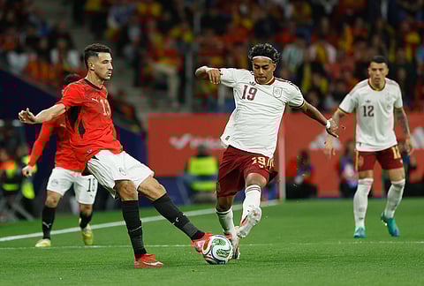 Spain's Lamine Yamal, right, challenges for the ball with Egypt's Ahmed Fatouh during the international friendly soccer match between Spain and Egypt in Barcelona, Spain.