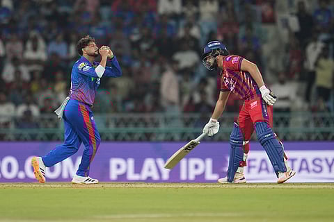 Delhi Capitals' Kuldeep Yadav, left, takes the catch off his own bowling to dismiss Lucknow Super Giants' Mukul Choudhary during the Indian Premier League cricket match between Lucknow Super Giants and Delhi Capitals in Lucknow, India.