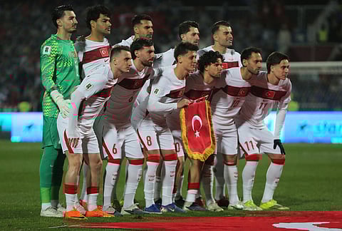 Turkey's players stand for a team photo ahead of the World Cup qualifying playoff final soccer match between Kosovo and Turkey in Pristina, Kosovo.