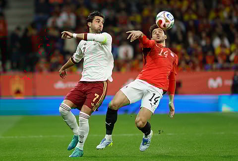 Spain's Ferran Torres, left, challenges for the ball with Egypt's Hamdy Fathy during the international friendly soccer match between Spain and Egypt in Barcelona, Spain.