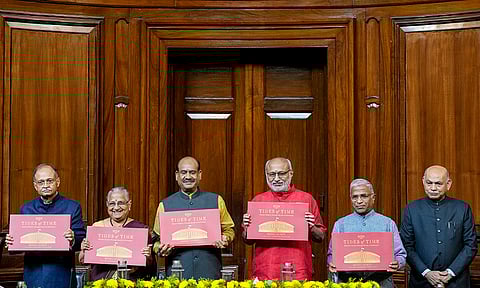 Vice President CP Radhakrishnan, third right, Lok Sabha Speaker Om Birla, third left, Deputy Chairman of the Rajya Sabha Harivansh Narayan Singh, second right, 
Secretary General of the Rajya Sabha Pramod Chandra Mody, right, Secretary General of the Lok Sabha Utpal Kumar Singh, left, and MP Sudha Murty during the launch of Murty's book "Tides of Time", in New Delhi.