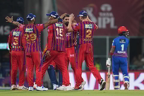 Lucknow Super Giants' Mohammed Shami, center without cap, celebrates with teammates the dismissal of Delhi Capitals' KL Rahul, right, during the Indian Premier League cricket match between Lucknow Super Giants and Delhi Capitals in Lucknow, India.
