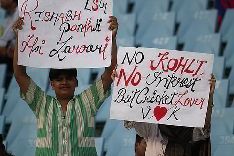 Fans display placards before the start of the Indian Premier League cricket match between Lucknow Super Giants and Delhi Capitals in Lucknow, India.