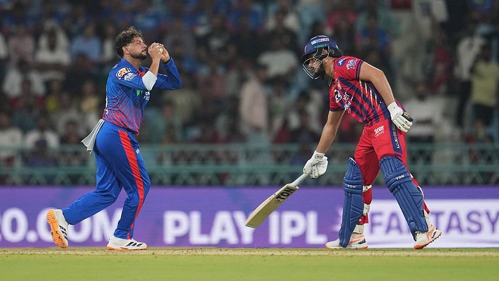 Delhi Capitals' Kuldeep Yadav, left, takes the catch off his own bowling to dismiss Lucknow Super Giants' Mukul Choudhary during the Indian Premier League cricket match between Lucknow Super Giants and Delhi Capitals in Lucknow, India. - | Photo: AP/Manish Swarup