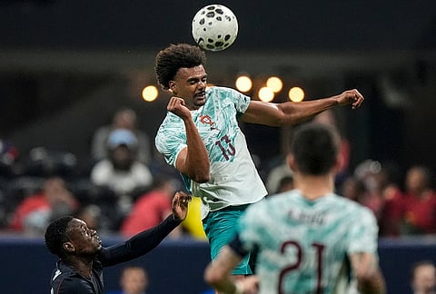 Portugal's Renato Veiga (13) hits the ball against USA's Folarin Balogun (20) during the second half of an international friendly soccer match, in Atlanta.
