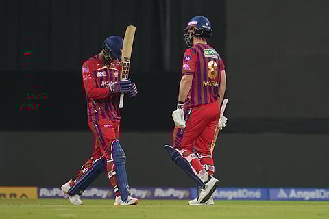 Lucknow Super Giants' Mitchell Marsh, right, walks off the field after losing his wicket as teammate Mukul Choudhary walks in to bat during the Indian Premier League cricket match between Lucknow Super Giants and Delhi Capitals in Lucknow, India.