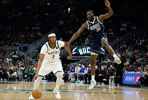 Milwaukee Bucks center Myles Turner (3) drives against Dallas Mavericks center Moussa Cisse (30) during the first half of an NBA basketball game in Milwaukee.
