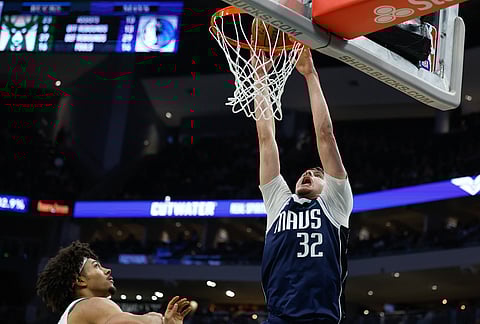 Dallas Mavericks forward Cooper Flagg (32) dunk against Milwaukee Bucks during the second half of an NBA basketball game in Milwaukee. 
