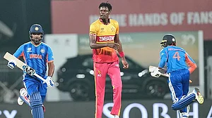 AP : Sanju Samson, left, and Abhishek Sharma, right, run between the wickets as Blessing Muzarabani looks on during the T20 World Cup cricket match between India and Zimbabwe in Chennai.