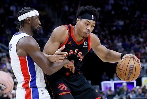 Toronto Raptors forward Scottie Barnes (4) drives against Detroit Pistons guard Ausar Thompson during the first half of an NBA basketball game in Detroit.