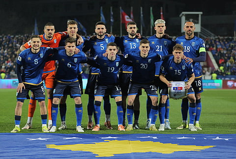 Kosovo's players stand for a team photo ahead of the World Cup qualifying playoff final soccer match between Kosovo and Turkey in Pristina, Kosovo.