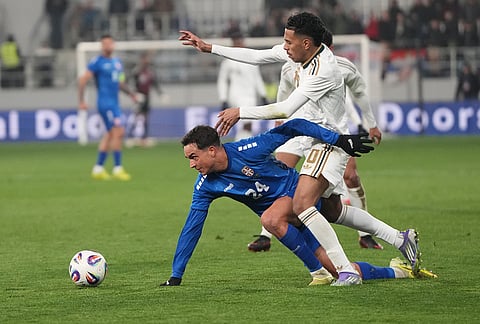Serbia's Petar Stanic, centre, and Saudi Arabia's Musab Aljuwayr challenge for the ball during the international friendly soccer match between Serbia and Saudi Arabia in Backa Topola, Serbia.