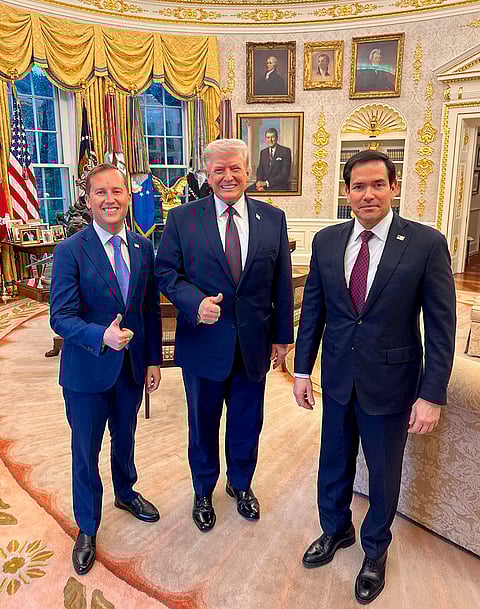 US President Donald Trump, centre, poses for photographs with US Ambassador to India Sergio Gor, left, at the White House, in Washington, DC. 