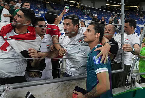 Iraq's Ibraham Bayesh celebrates with fans after the World Cup playoff final soccer match between Iraq and Bolivia in Monterrey, Mexico.