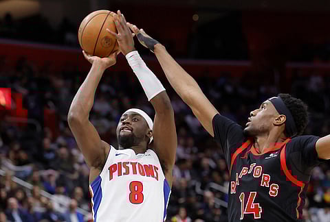 Detroit Pistons guard Caris LeVert (8) takes a shot while being defended by Toronto Raptors guard Ja'kobe Walter (14) during the second half of an NBA basketball game in Detroit.