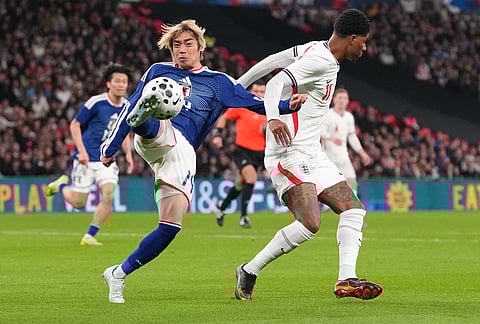 Japan's Junya Ito, left, and England's Marcus Rashford challenge for the ball during the International friendly soccer match between England and Japan in London.