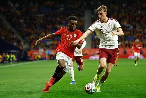 Egypt's Haissem Hassan, left, challenges for the ball with Spain's Dean Huijsen during the international friendly soccer match between Spain and Egypt in Barcelona, Spain.