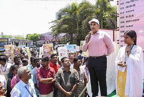 Madurai District Collector KJ Praveen Kumar, right, addresses the gathering regarding the use of Electronic Voting Machine (EVM) to first-time voters ahead of the Tamil Nadu Assembly Election, at Mattuthavani bus stand complex in Madurai.