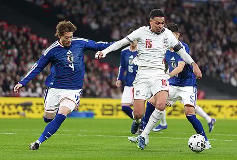 Japan's Ayumu Seko, left, and England's Morgan Rogers challenge for the ball during the International friendly soccer match between England and Japan in London.