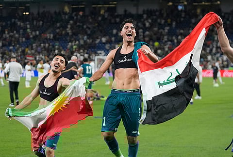Iraq's players celebrate after the World Cup playoff final soccer match between Iraq and Bolivia in Monterrey, Mexico.