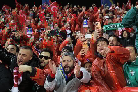 Turkey's supporters celebrate after winning the World Cup qualifying playoff final soccer match between Kosovo and Turkey in Pristina, Kosovo