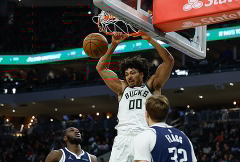 Milwaukee Bucks center Jericho Sims (00) dunks against the Dallas Mavericks during the first half of an NBA basketball game in Milwaukee.