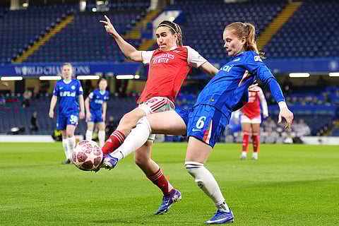 Arsenal's Mariona Caldentey, left, and Chelsea's Sjoeke Nusken battle for the ball during the Women's Champions League quarterfinal second leg soccer match between Chelsea and Arsenal in London.