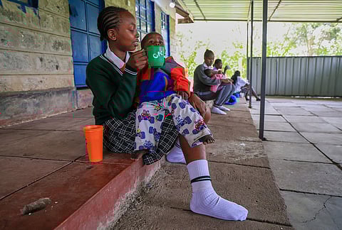 Valarie Wairimu, 19, feeds her son Kayden Darmain during breaktime at Greenland Girls School in Kajiado, Kenya.