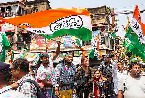TMC supporters shout slogans during a BJP roadshow for filing of nomination papers, in Kolkata, West Bengal.