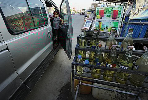 Gasoline bottles are displayed at a vendor's shop in Phnom Penh, Cambodia, Monday, March 30, 2026. 
