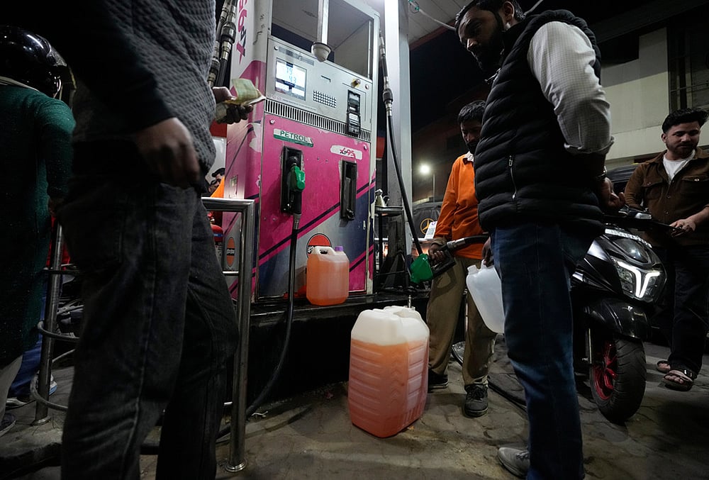 People store fuel in a plastic can at a petrol pump amid fears of a possible shortage due to the US Iran war, in Srinagar March 25, 2026.  - | Photo: AP/Mukhtar Khan