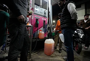| Photo: AP/Mukhtar Khan : People store fuel in a plastic can at a petrol pump amid fears of a possible shortage due to the US Iran war, in Srinagar March 25, 2026.