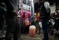| Photo: AP/Mukhtar Khan : People store fuel in a plastic can at a petrol pump amid fears of a possible shortage due to the US Iran war, in Srinagar March 25, 2026. 