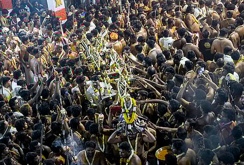 'Veerakumars' holding swords, perform rituals during the 'Bengaluru Karaga' festival, at Shri Dharmaraya Swamy Temple, in Bengaluru, Karnataka.