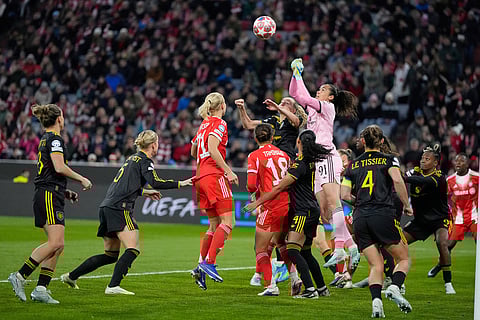 Manchester United's goalkeeper Phallon Tullis-Joyce leaps for the ball during the Women's Champions League quarterfinal second leg soccer match between Bayern Munich and Manchester United in Munich, Germany.