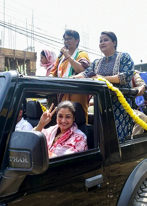 All India Mahila Congress President Alka Lamba, front, greets the gathering during an election campaign in support of Congress candidate for Dispur constituency, Mira Borthakur Goswami, back centre, ahead of Assam Assembly Election, in Guwahati.