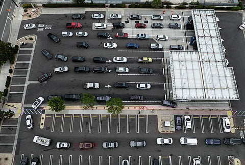 Motorists wait in line to fill their tanks at a Costco gas station, in Los Angeles.