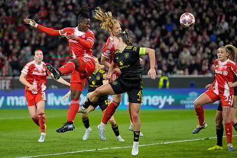 Bayern's Glodis Viggosdottir, centre rear, scores her sides first goal during the Women's Champions League quarterfinal second leg soccer match between Bayern Munich and Manchester United in Munich, Germany.