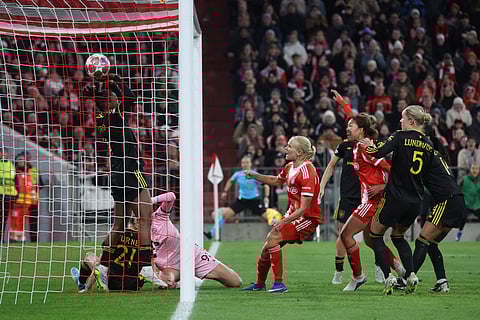 The ball lands behin Manchester United's goalkeeper Phallon Tullis-Joyce bottom left to make it 1-1 during the Women's Champions League quarterfinal second leg soccer match between Bayern Munich and Manchester United in Munich, Germany.