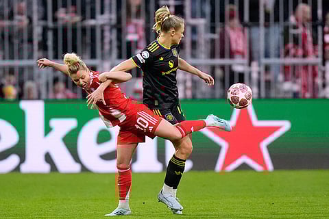 Bayern's Linda Dallmann competes for the ball with Manchester United's Fridolina Rolfo during the Women's Champions League quarterfinal second leg soccer match between Bayern Munich and Manchester United in Munich, Germany.