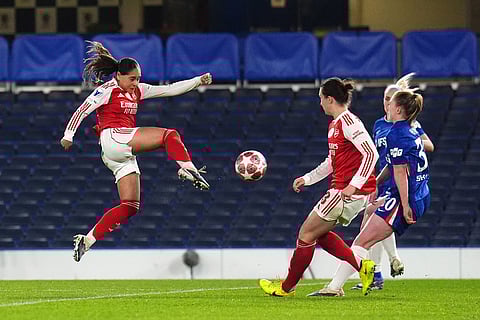 Arsenal's Olivia Smith, left, shoots the ball during the Women's Champions League quarterfinal second leg soccer match between Chelsea and Arsenal in London.