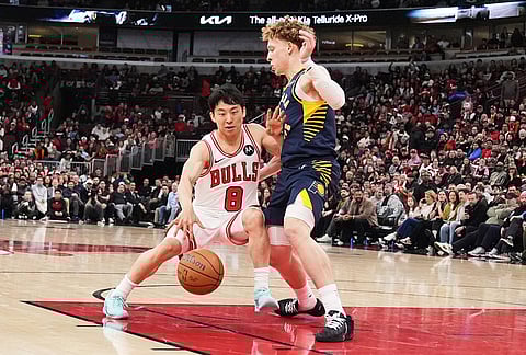 Chicago Bulls guard Yuki Kawamura, left, of Japan, drives against Indiana Pacers guard Taelon Peter during the first half of an NBA basketball game, in Chicago.
