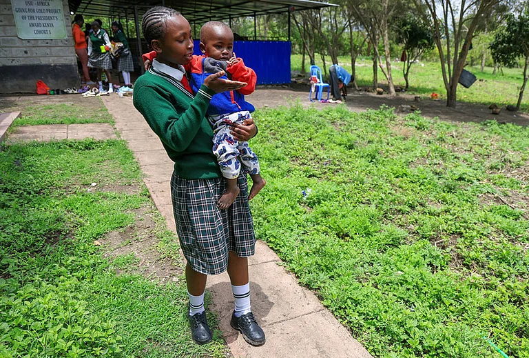 Valarie Wairimu, 19, interacts with her son, Kayden Darmain during breaktime at Greenland Girls School in Kiserian, Kajiado, Kenya. - | Photo: AP/Andrew Kasuku