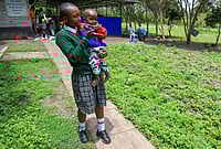 | Photo: AP/Andrew Kasuku : Valarie Wairimu, 19, interacts with her son, Kayden Darmain during breaktime at Greenland Girls School in Kiserian, Kajiado, Kenya. 