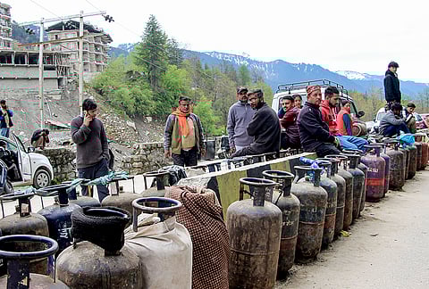 People wait in a queue to refill LPG cylinders amid disruptions due to the ongoing West Asia war, in Manali, Himachal Pradesh.