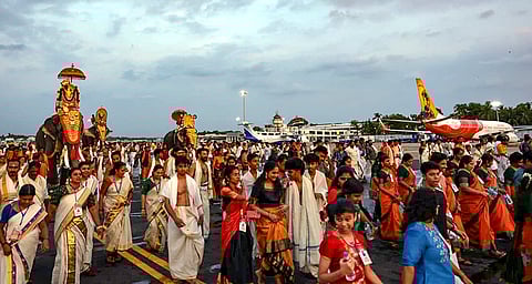 Devotees make their way through a runway at the Thiruvananthapuram International Airport for the holy 'Painkuni Arattu' festival of Sree Padmanabhaswamy Temple.